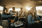 Group of friends on a road trip inside a car, laughing and relaxed